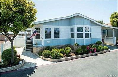 Exterior is beautifully landscaped with vinyl fencing.