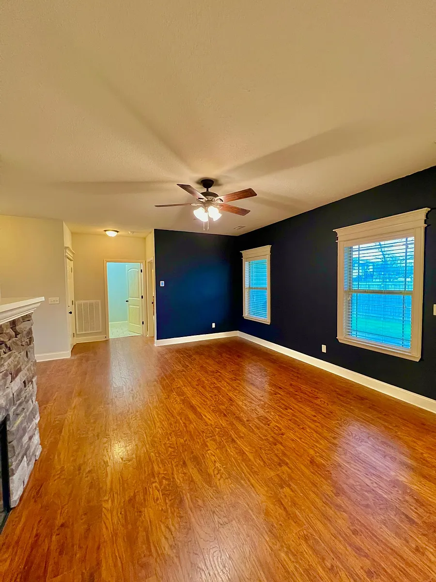 Living room with navy accent wall. - 5823 McKinley St