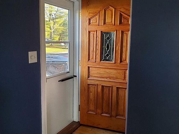 storm door with self storing screen and solid oak interior front door