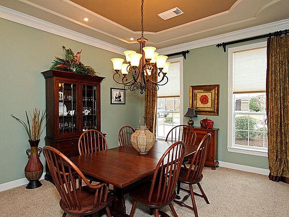 Beautiful accented ceiling adds a touch of elegance to the large formal dining room.