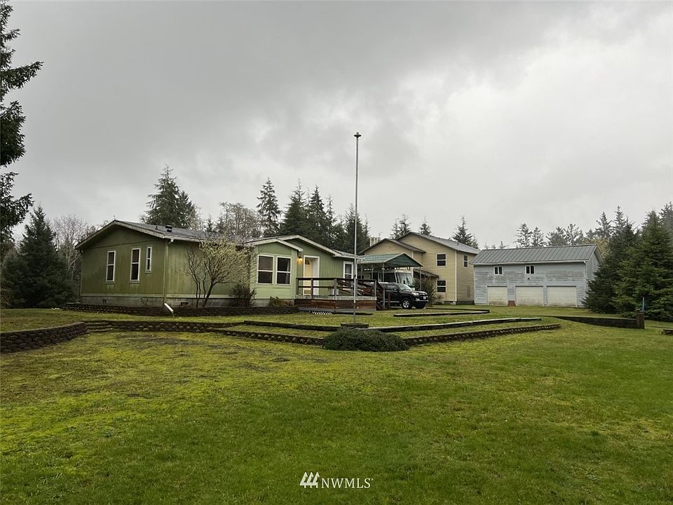 Multi buliding on 5.1 acre: MH 1,288 sqft, 3 bay garage and 864 sqft with rec room above and 3,430 sqft unfinished 2nd residence.