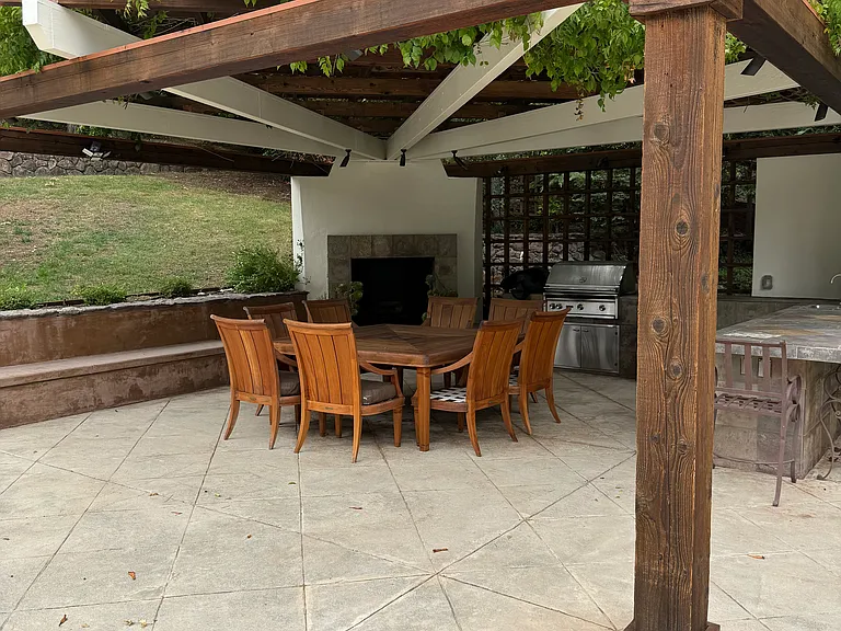 Outdoor kitchen, woodburning fireplace and dining area