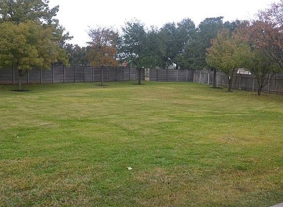 Huge private backyard with medium sized trees