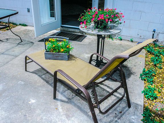 Enjoy the beautiful Florida sunshine on this private patio with a book or good friends.