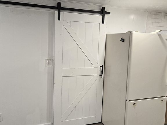 That is the door to the bedrooms.In the hallway in the bathroom and the laundry room.