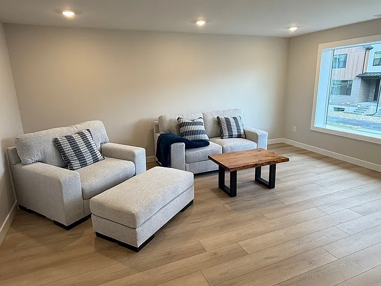 Downstairs. Large open room with 65" TV and entrance to hike and bike trail