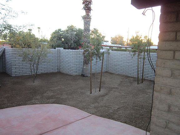 New concrete patio, enclosed by new masonary wall; new drip