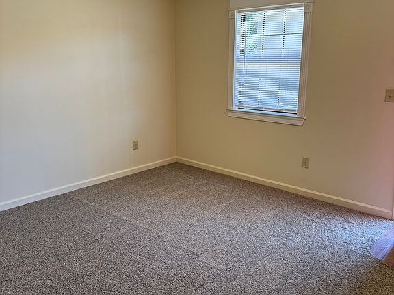 Living Room with new paint/carpet, ceiling fan, crown moldings.