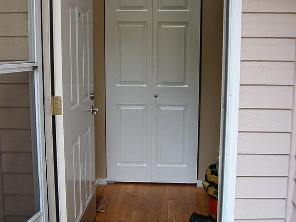 Main entrance with hard wood floor and coat closet
