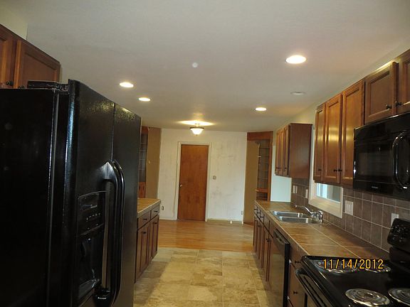 Kitchen looking to garage door. The wood is the spot for a table