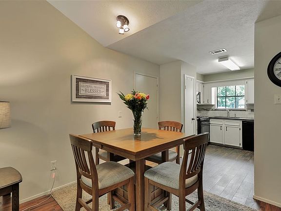 Dining area also has the solid surface wood look tiled flooring as well as the kitchen !