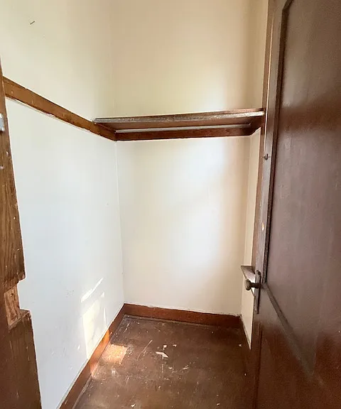 Large coat/storage room in hall outside of unit (before being painted)
