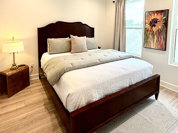 Guest bedroom features 5-star hotel quality plush mattress and linens. Wall mounted smart TV. Ensuite bathroom