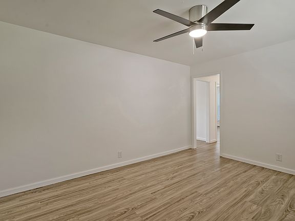 Living room- new flooring, ceiling fan and blinds