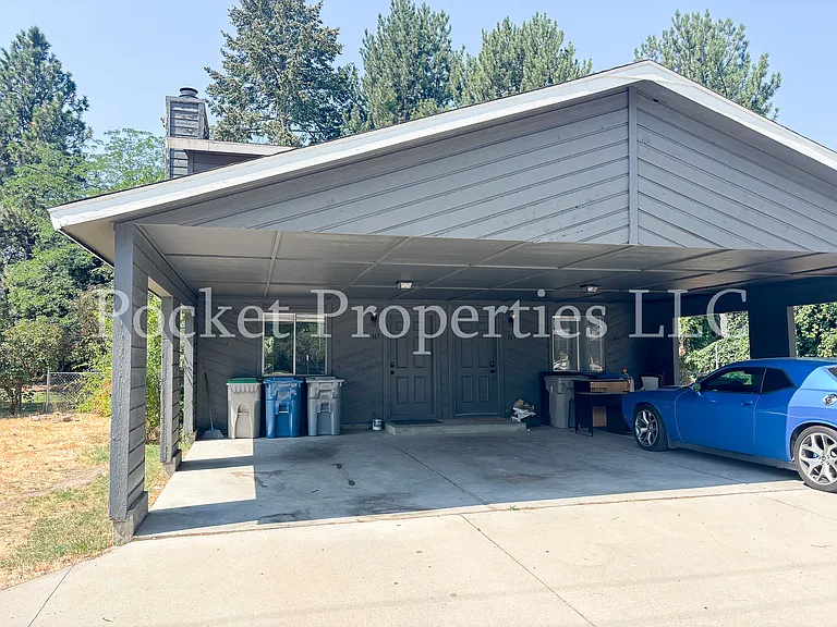 Exterior view of property, shared carport parking with one other unit