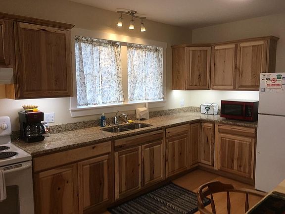 The lovely kitchen features granite countertops, lots of task lighting, and beautiful cabinets.