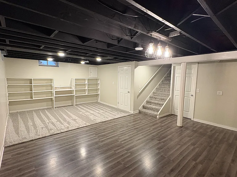 Basement living space with built-ins.
