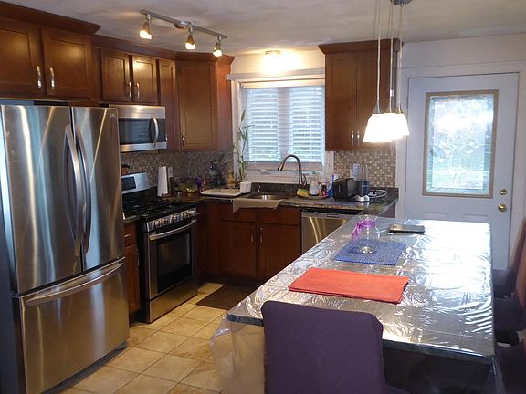 Another view of kitchen with the front entrance door seen on the right.