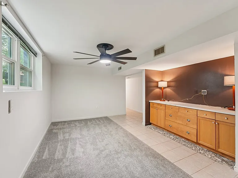 This spacious bonus area offers a charming blend of comfort and function, with large windows, warm cabinetry, and room to relax, work, or unwind in peace.