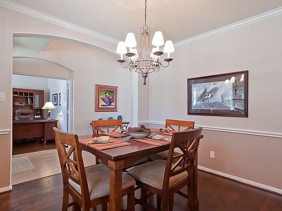 This photo of the dining room shows the flow of the entryway. The study is opposite the dining.