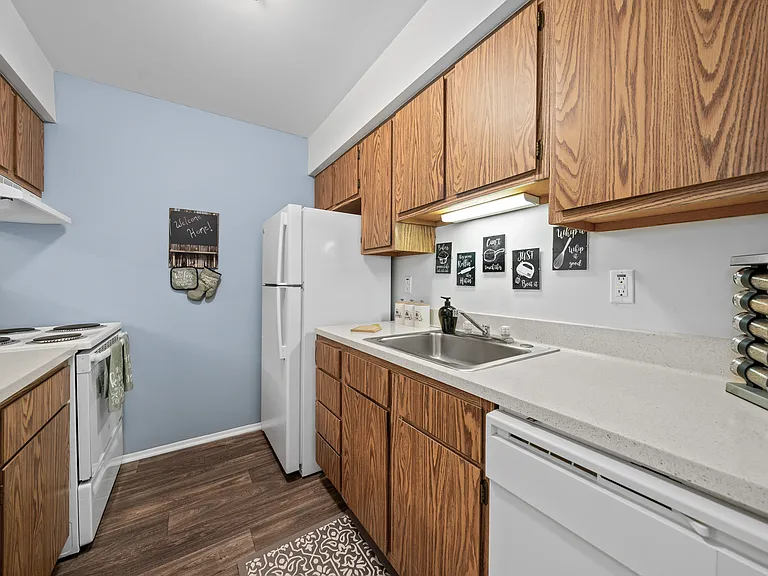 Efficient and cozy kitchen at Woodland Villa Apartments in Westland, MI.