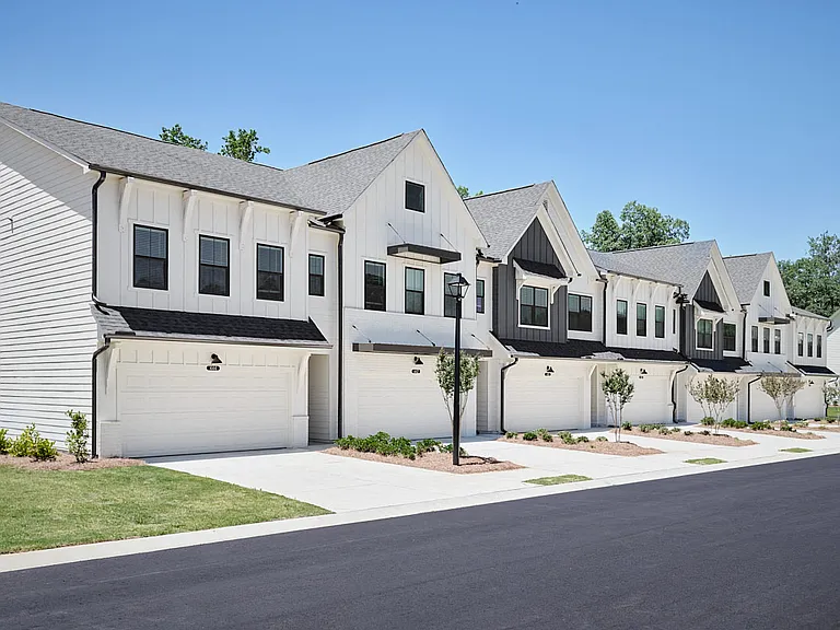 Exterior shot of the two townhomes with private driveways and attached garages.