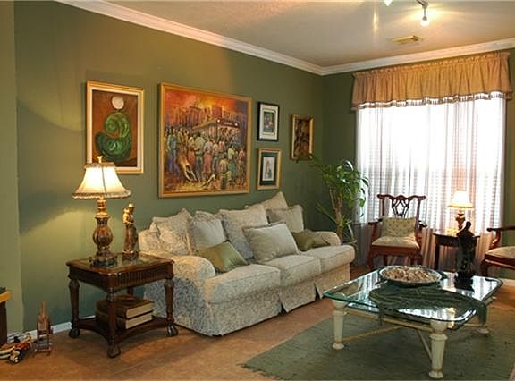 Inviting formal living with crown molding and tile floor