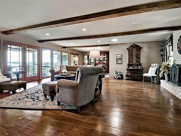 HUGE Main Living Area Opens into Dining Room, Enclosed Porch & Open Air Balcony Patio Offering so much Natural Light & Unobstructed Views of Beaver Lake...