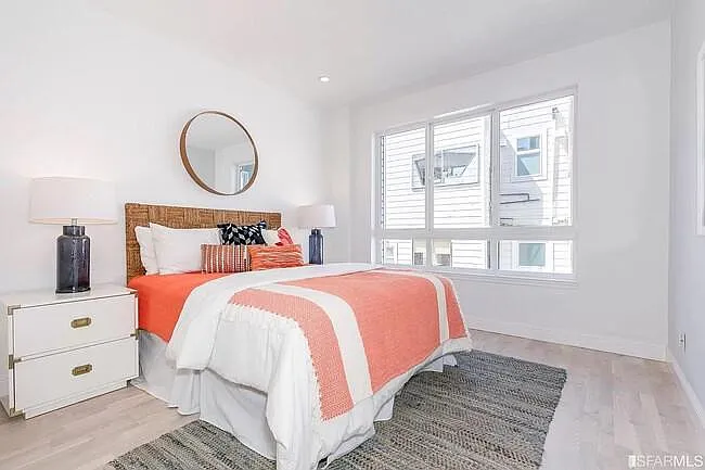 The guest bedroom. It fits a king-size bed. Big windows and a closet on the left.