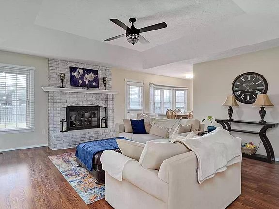Great room with stunning fireplace and luxury laminate wood floors.