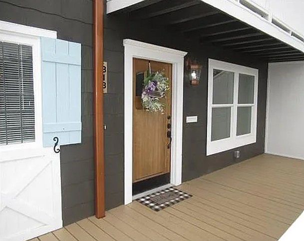 Front porch with beautiful front door and landscaped yard sets this unit apart from others on the same street