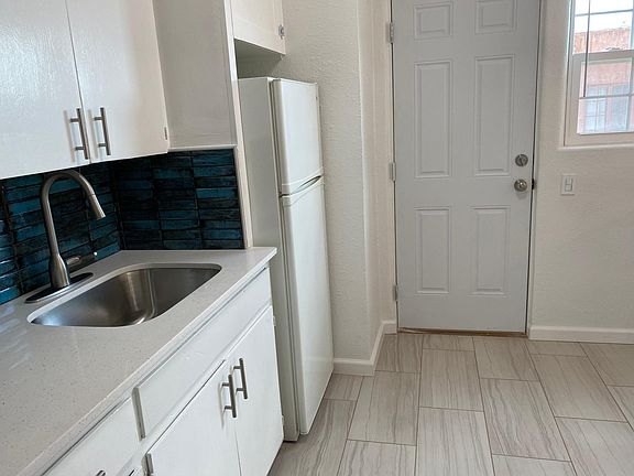 The property has two outside entries. One that goes into the kitchen as shown here. The other is the main entrance into the living room.