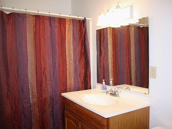 Updated Bath with new vanity, tub surround, lighting, and fixtures.