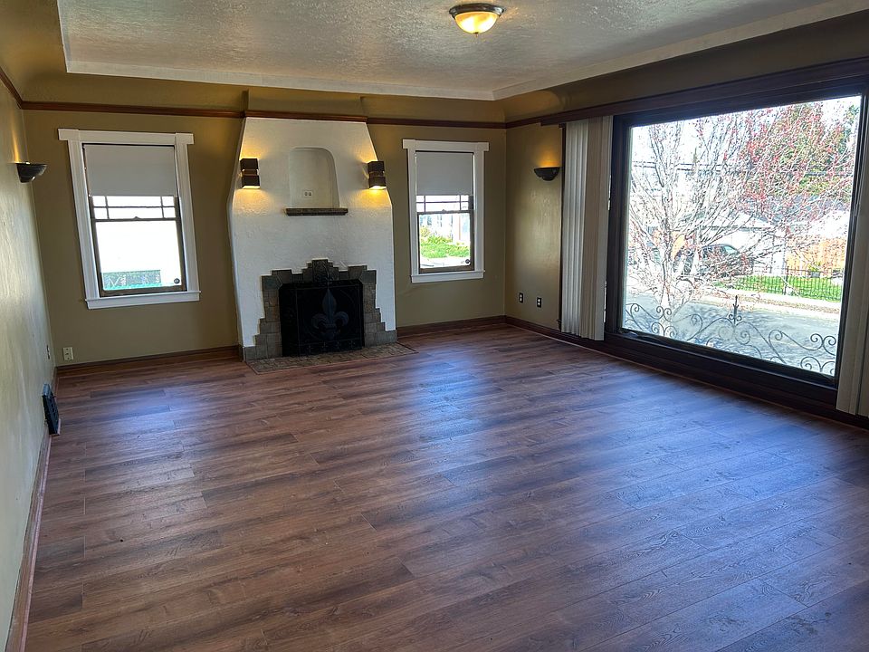 Main living room fireplace and wood flooring