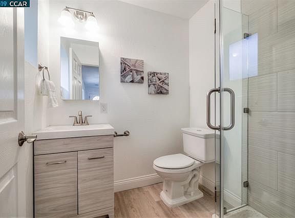 Stall shower and energy efficient toilet.