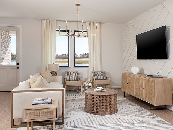 Family room featuring a custom accent wall and chandelier