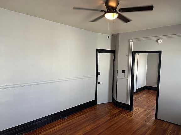 This is the living room with the front door and bedroom #1 door shown

Ceiling fan and hardwood flooring