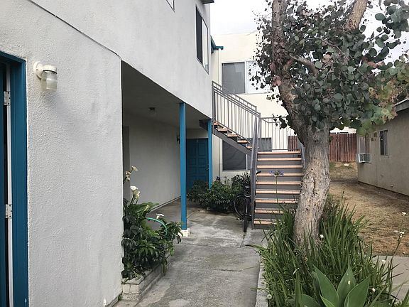 Unit #B located under stairs. Coin laundry on the left