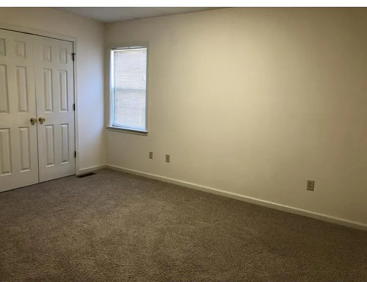 guest bedroom w carpeting accomodates up to a king size bed
