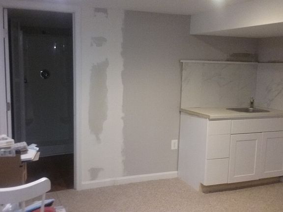 Kitchnette installation in progress. Apt-size refrigerator w