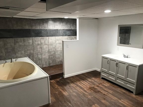 Bathroom - tub plus walk-in shower behind partition wall.