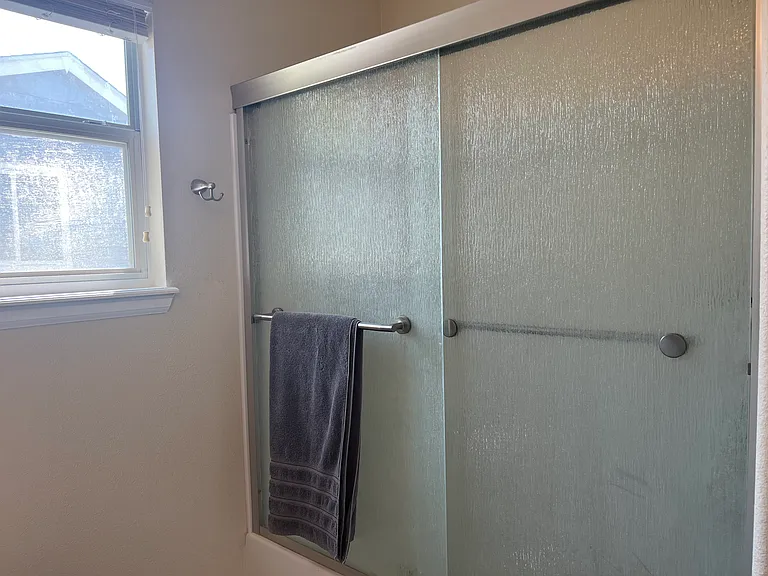 Shower and tub combo in owner's suite bathroom