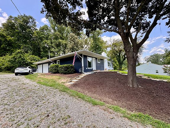 House sits far back from road with plenty of driveway space and private back yard backs to woods. Large two car garage with work bench.