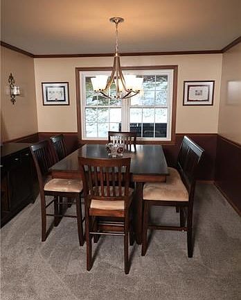 Dining room offers a chair rail, and crown molding, and a bright window to the rear yard.