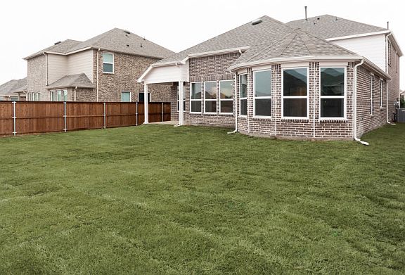 Spacious, fenced-in backyard with covered patio