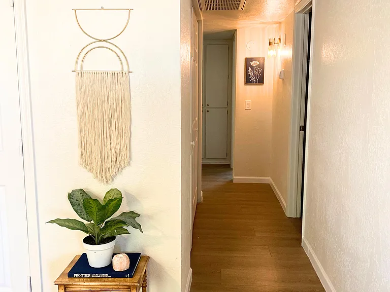 Hallway leading into bathroom and rooms.