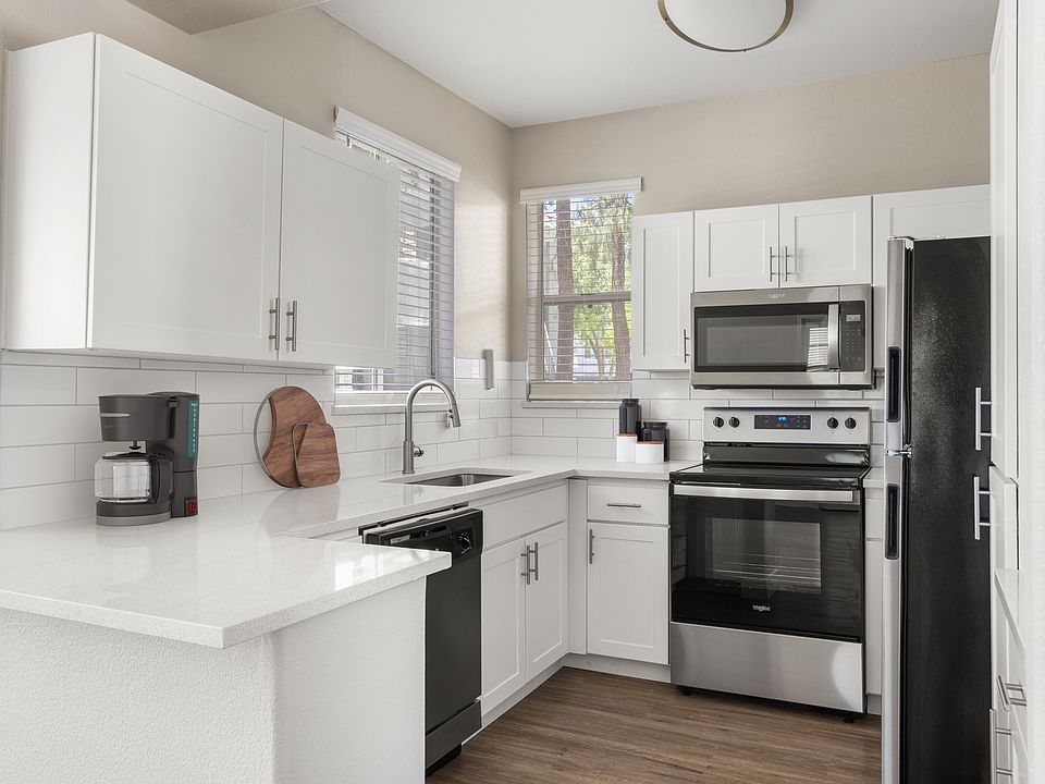 Modern interiors showcase wood-style plank flooring, upgraded cabinetry, quartz countertops with undermount sinks, and stainless-steel appliances