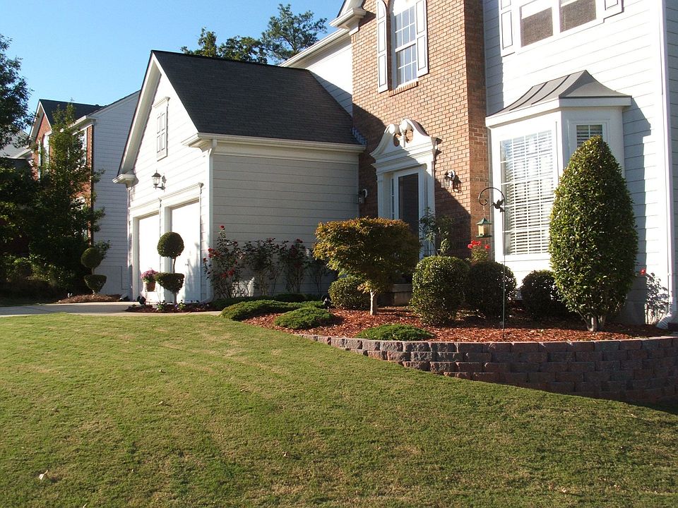 Stone wall. Mature shrubs.
