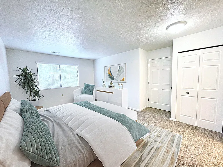 Large Carpeted Bedroom with Overhead Light