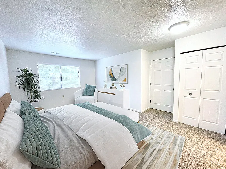 Large Carpeted Bedroom with Overhead Light
